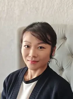 Dr. Angel Lu, chiropractor at Angel Chiropractic, seated in clinic