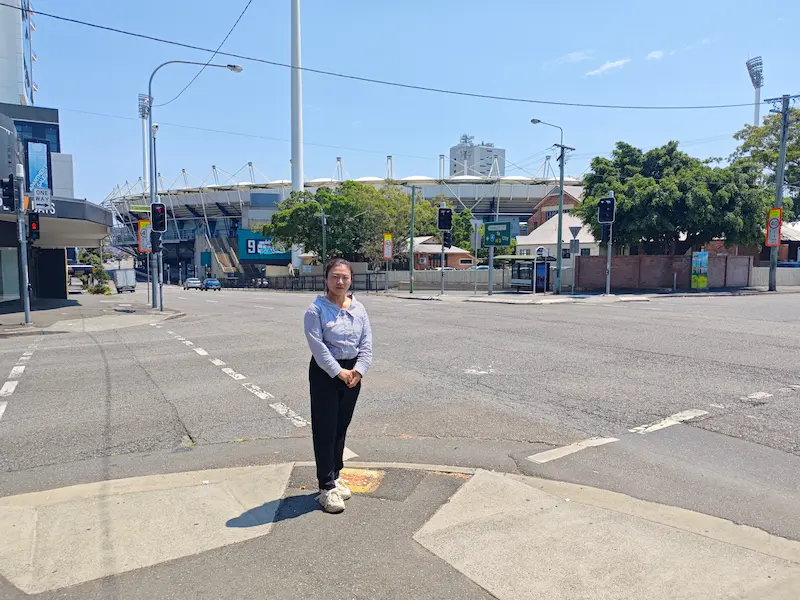 Dr Angel from Angel Chiropractic standing outside The Gabba in Woolloongabba, showing her commitment to supporting the local community’s health and wellbeing.