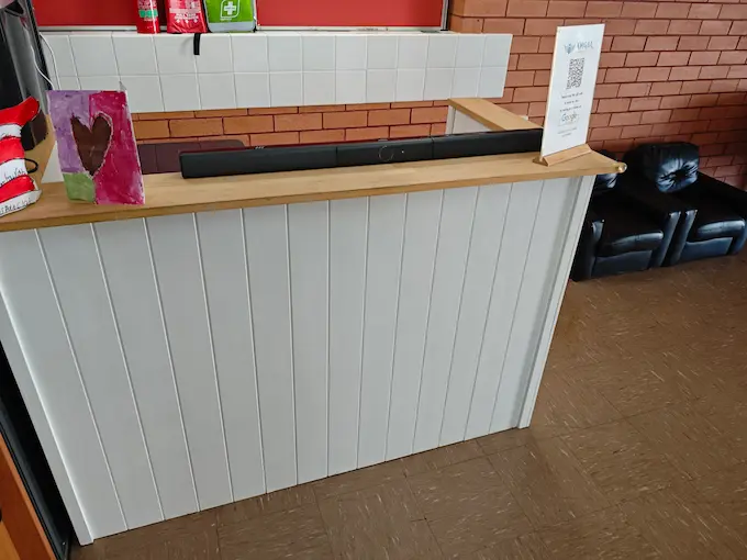 Reception desk at Angel Chiropractic Brisbane with welcoming staff, modern design, and organized patient check-in area