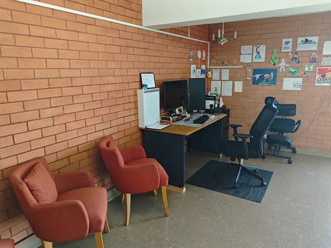Consultation area at Angel Chiropractic Brisbane with desk, chairs, and patient-friendly environment for chiropractic assessments