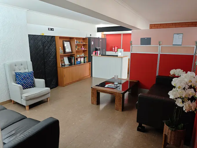 View from the entrance of Angel Chiropractic Brisbane showing welcoming waiting area with comfortable seating, bright natural light.