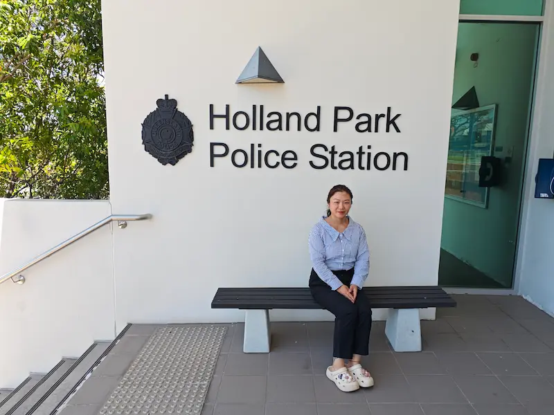 Dr Angel from Angel Chiropractic standing at the Holland Park Police Station, representing local chiropractic care for Holland Park residents.
