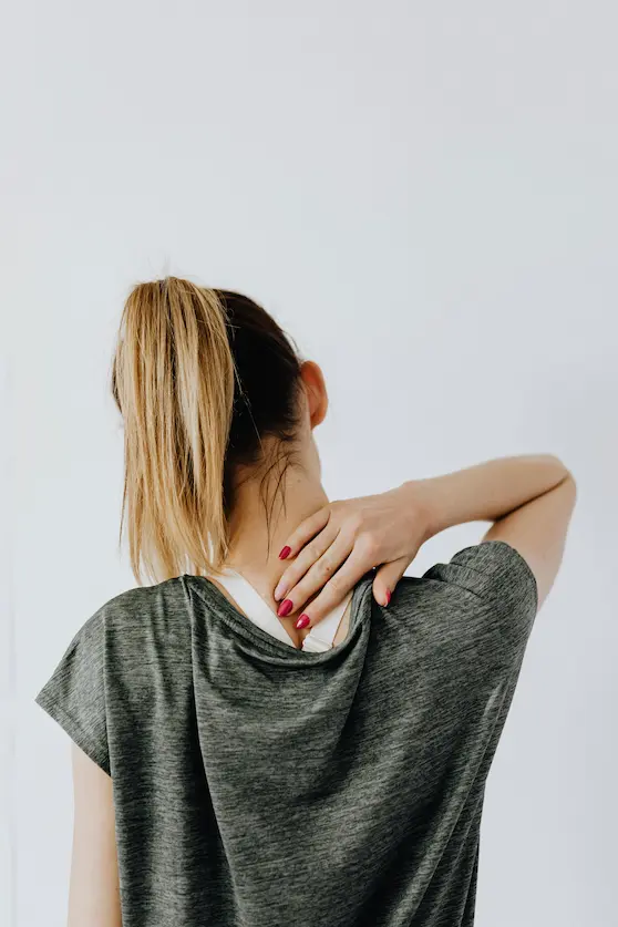 Woman holding the back of her neck with pain – Back of Neck Pain Brisbane treated at Angel Chiropractic